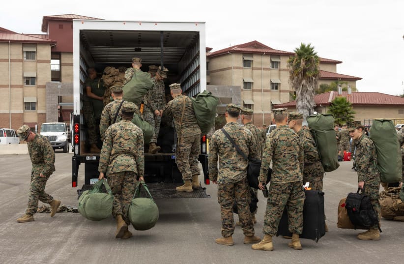 US Marines assigned to the 13th Marine Expeditionary Unit, load their gear into a box truck at Marine Corps Base Camp Pendleton, California, Sept. 26, 2026.