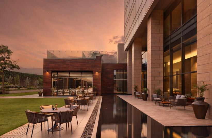 Outdoor seating at The Creek restaurant at The Den Bengaluru in Bengaluru, India.