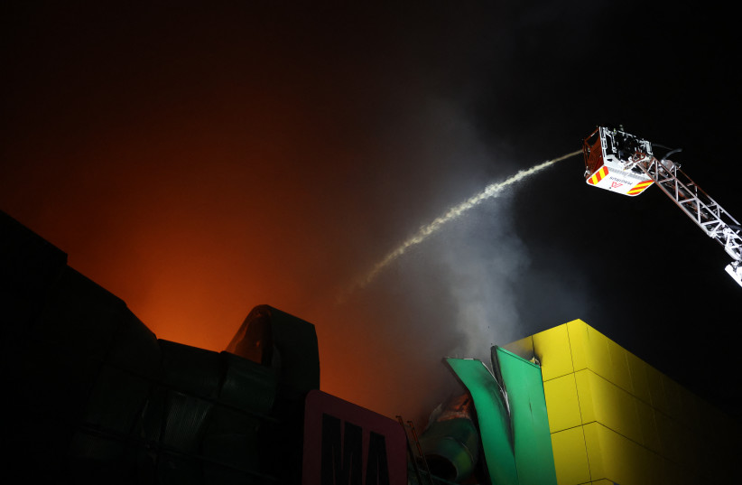 Ukrainian firefighters work at the site of a shopping centre damaged following a missile strike in Kyiv on October 22, 2026, amid the Russian invasion of Ukraine.