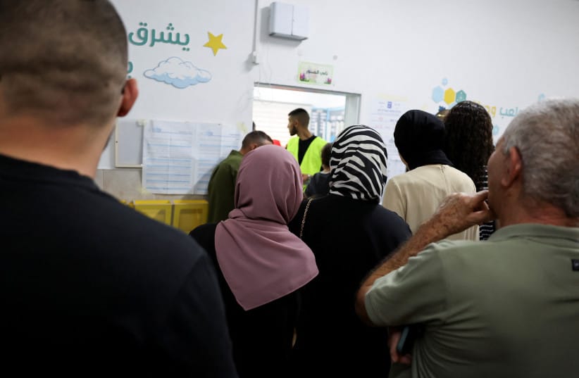 People stand in a queue to vote during the national election, at a polling station in the Arab village of Taibe, northern Israel, October 27, 2026
