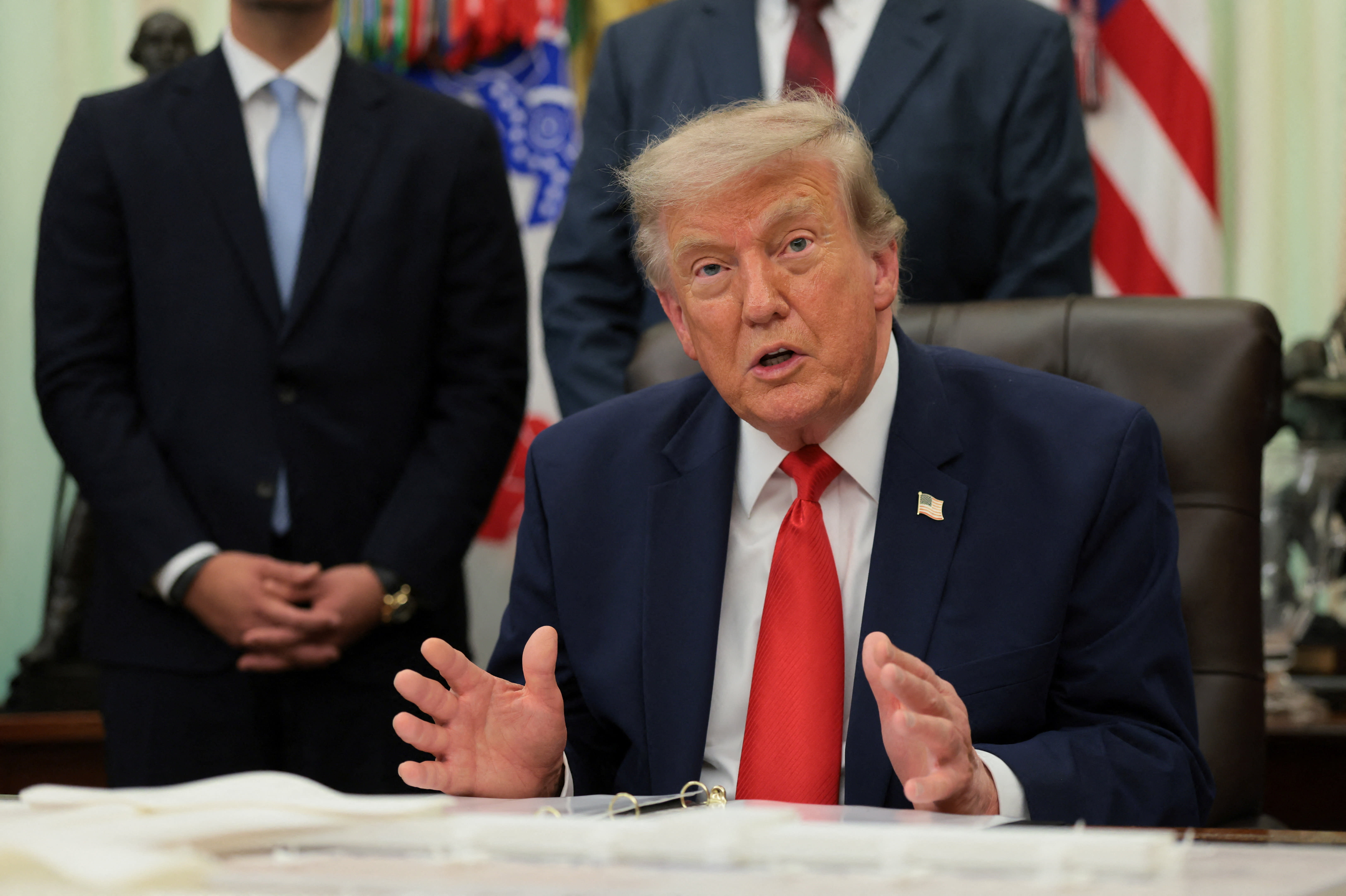 US President Donald Trump speaks as he sits behind an airport model as he makes an announcement about a renovation of Washington Dulles International Airport in the Oval Office at the White House in Washington, DC, US, July 29, 2026.