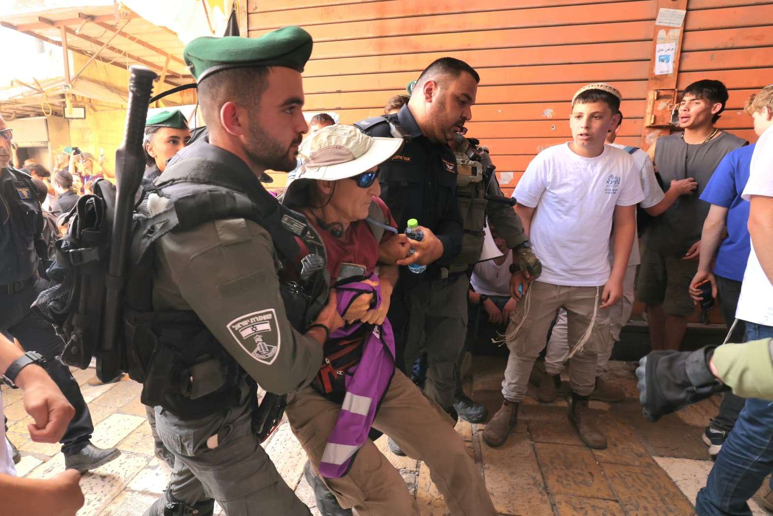 AN ACTIVIST being escorted out of the Old City ahead of the Jerusalem Day flag march, May 14, 2026. (photo credit: MARC ISRAEL SELLEM)