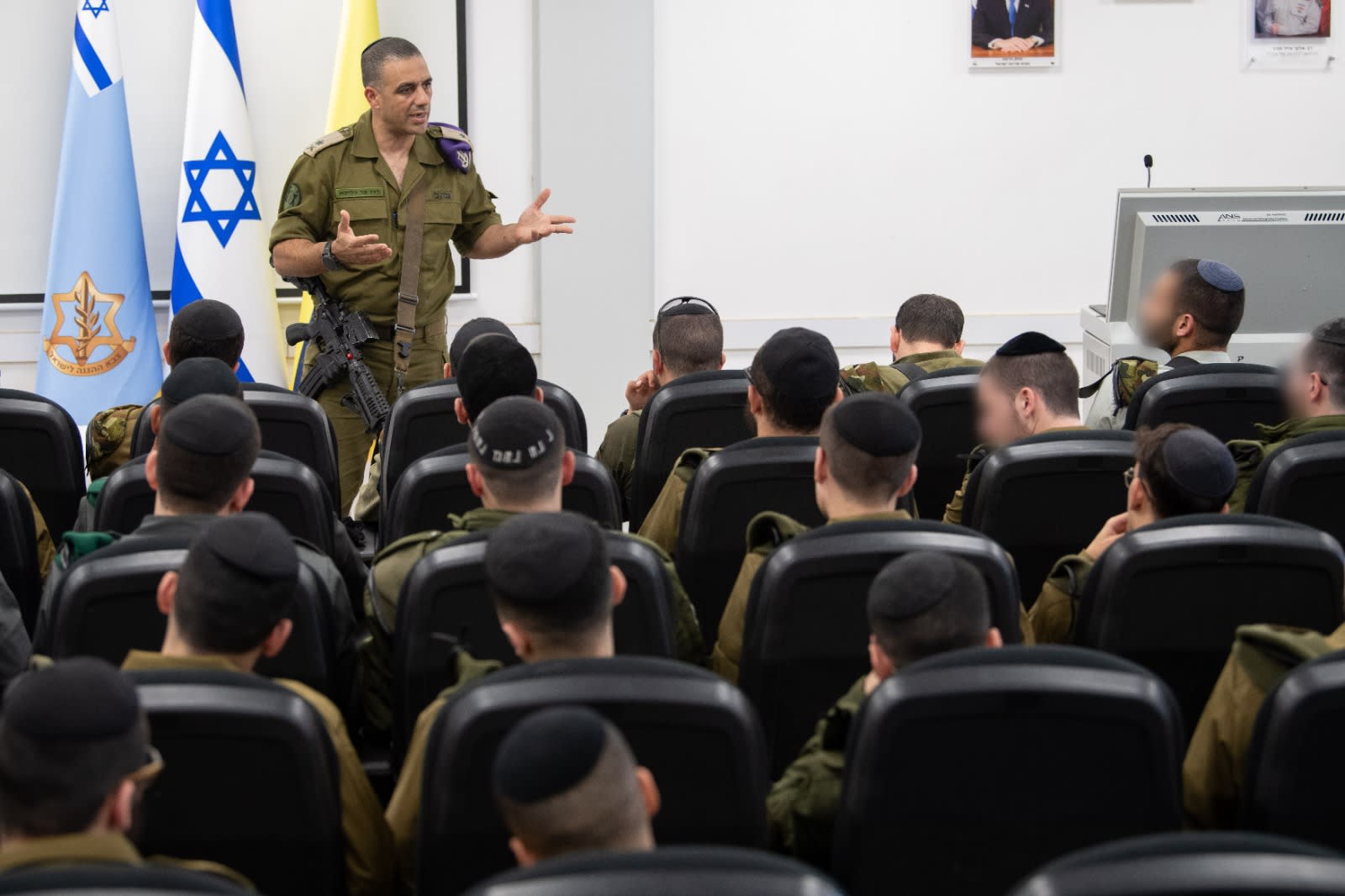 Maj.-Gen. Dado Bar Khalifa, head of the IDF’s Human Resources Department, addresses ultra-Orthodox recruits as they enlist in the military. (photo credit: IDF SPOKESPERSON