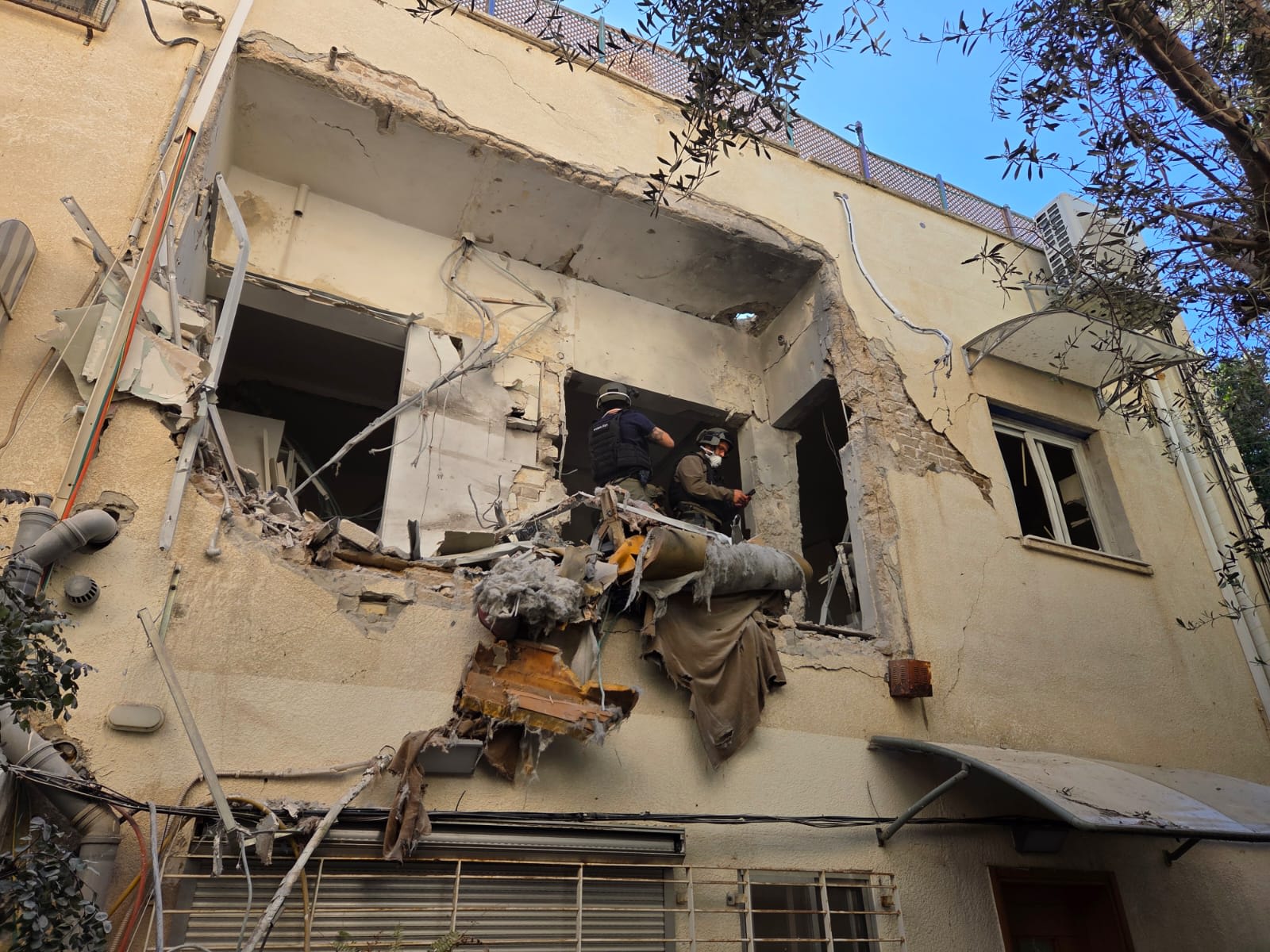 ISRAEL FIRE AND RESCUE work at a building damaged by a fallen Iranian missile fragment in central Israel, March 8, 2026. (photo credit: ISRAEL FIRE AND RESCUE AUTHORITY)