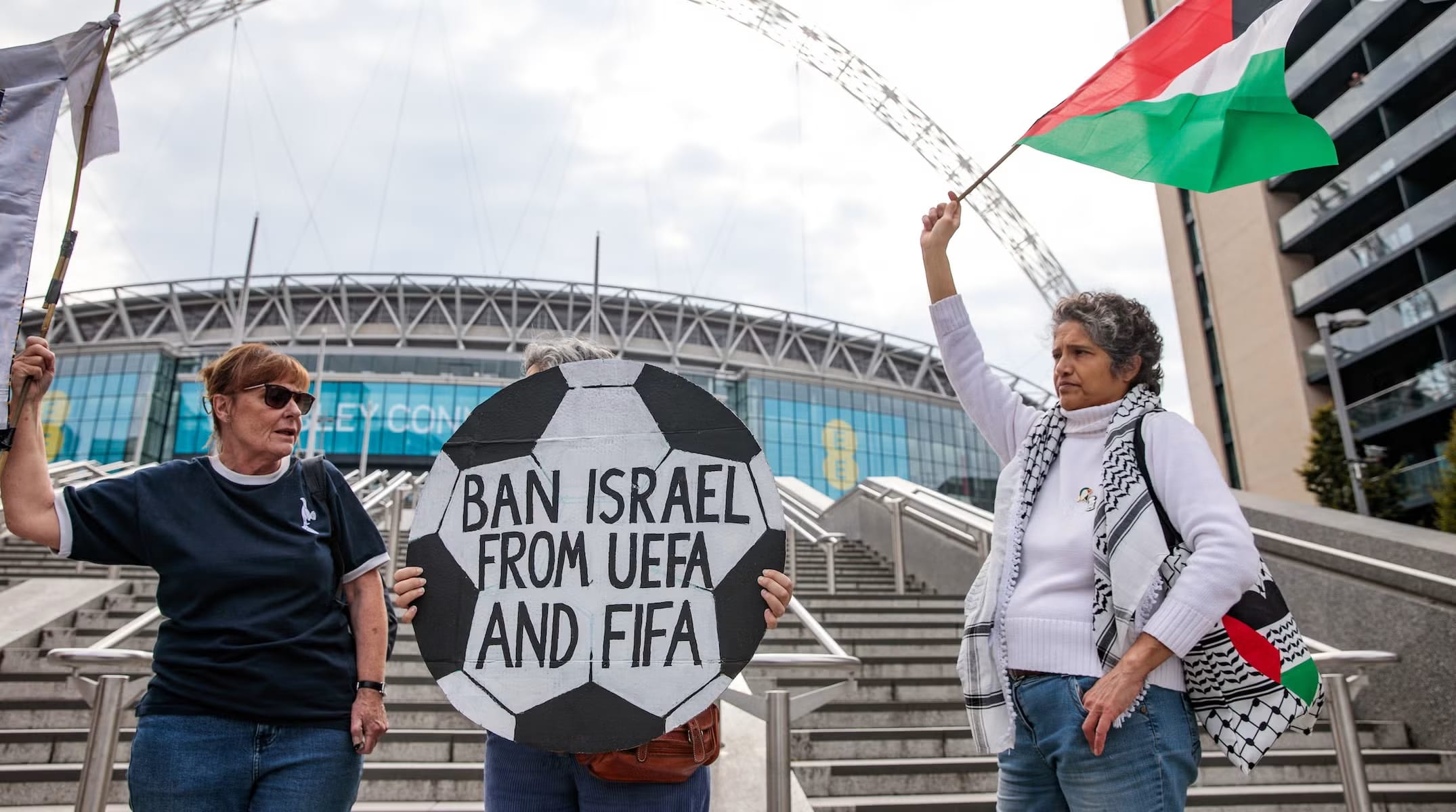 Pro-Palestinian activists protest with a football-shaped sign and a Palestinian flag outside Wembley Stadium on October 2nd, 2025 in London, United Kingdom. (photo credit: MARK KERRISON/IN PICTURES VIA GETTY IMAGES)