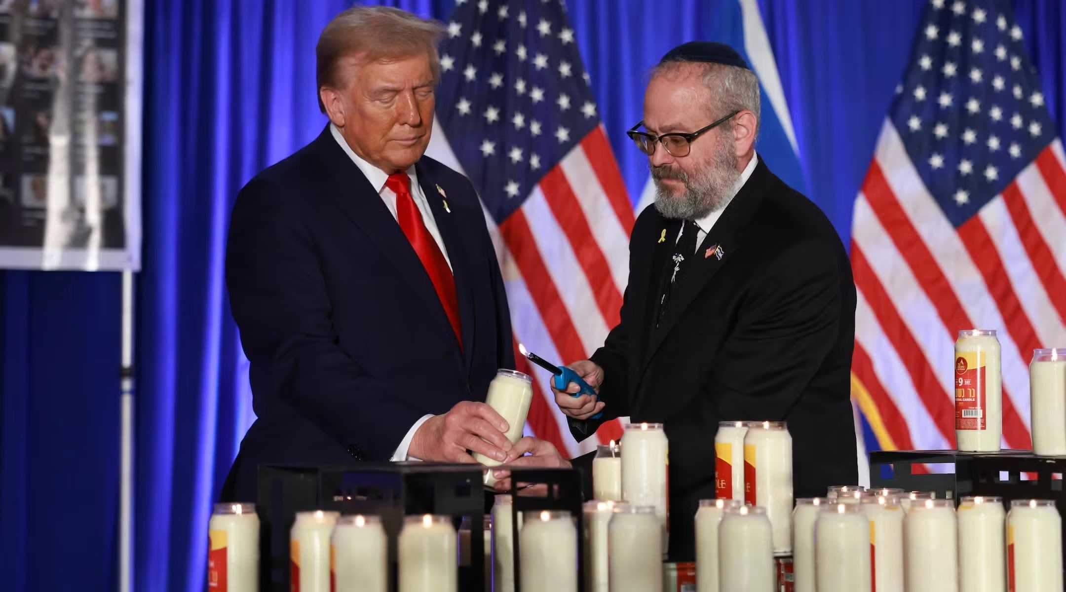 Donald Trump and Yehuda Kaploun light a candle during an Oct. 7 remembrance event at the Trump National Doral Golf Club in Doral, Florida on Oct. 07, 2024. (photo credit: JOE RAEDLE/GETTY IMAGES)