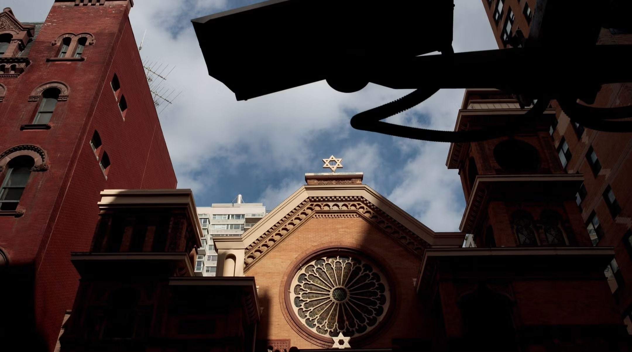 A security camera hangs across the street from the Park East Synagogue, in New York City. Jewish institutions are tightening security amid rising threats. (photo credit: DREW ANGERER/GETTY IMAGES)