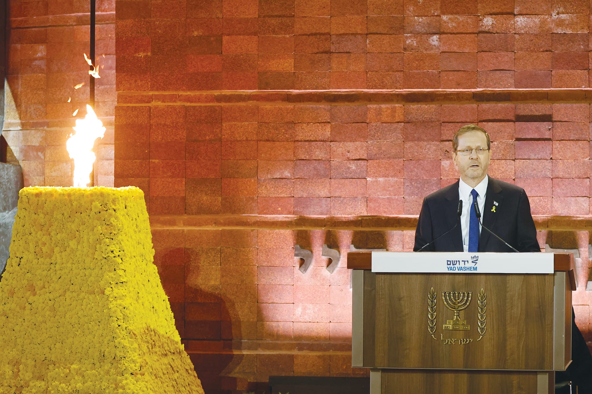 THIS YEAR’S eight survivors carry within them an enormous sweep of Jewish history: ghettos, pits, forests, camps, cattle cars, shootings, hiding places, and then, after all that, lives rebuilt in Israel. Here, President Isaac Herzog stands beside the memorial torch at Yad Vashem. (photo credit: MARC ISRAEL SELLEM/THE JERUSALEM POST)