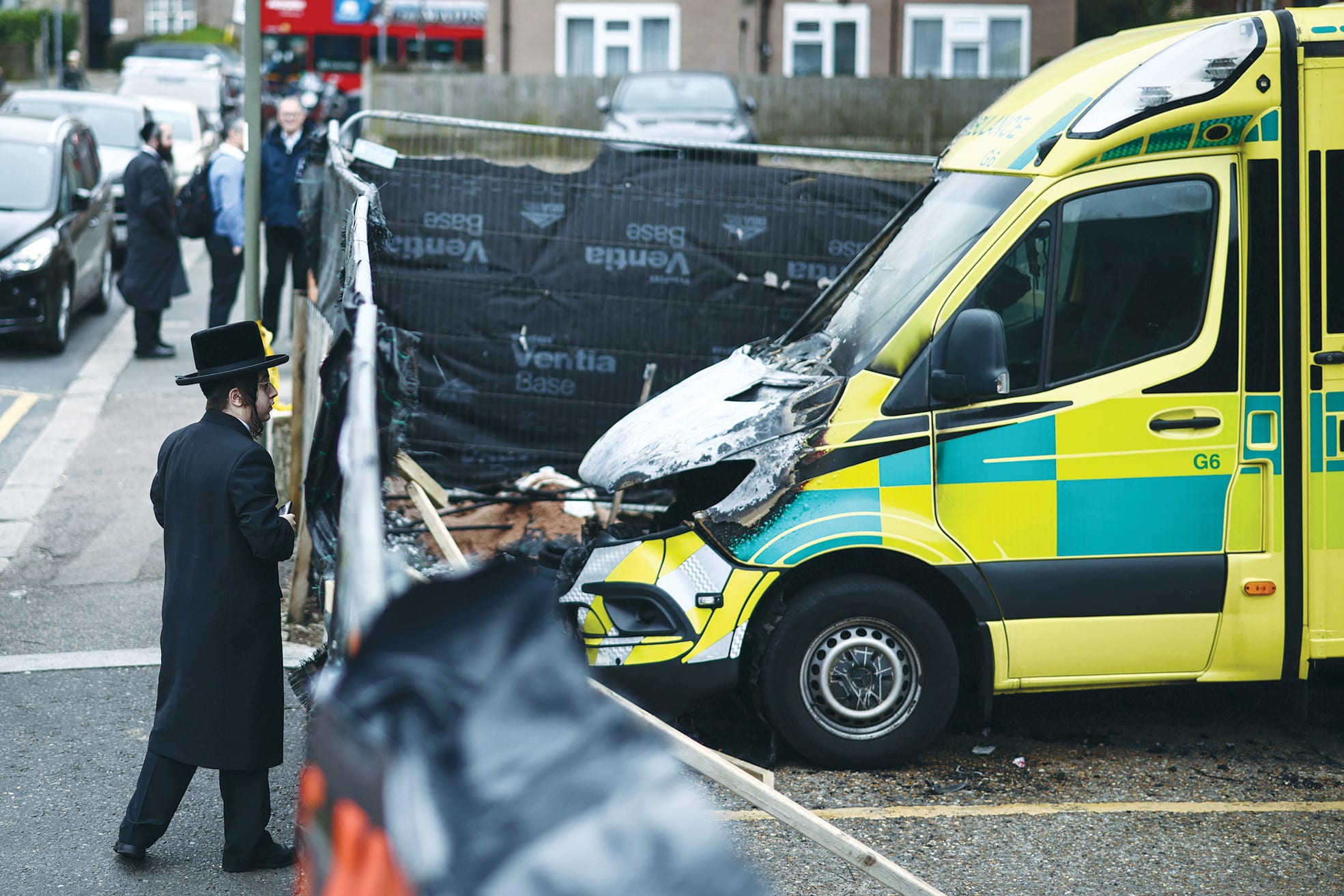 THE RISE of lone-actor terrorism in place of state-sponsored terror? Here, a member of the Jewish community views the scene of an antisemitic arson attack through a makeshift fence in London, on Tuesday, a day after volunteer ambulances run by a Jewish organization were set on fire. (photo credit: HENRY NICHOLLS/AFP VIA GETTY IMAGES)
