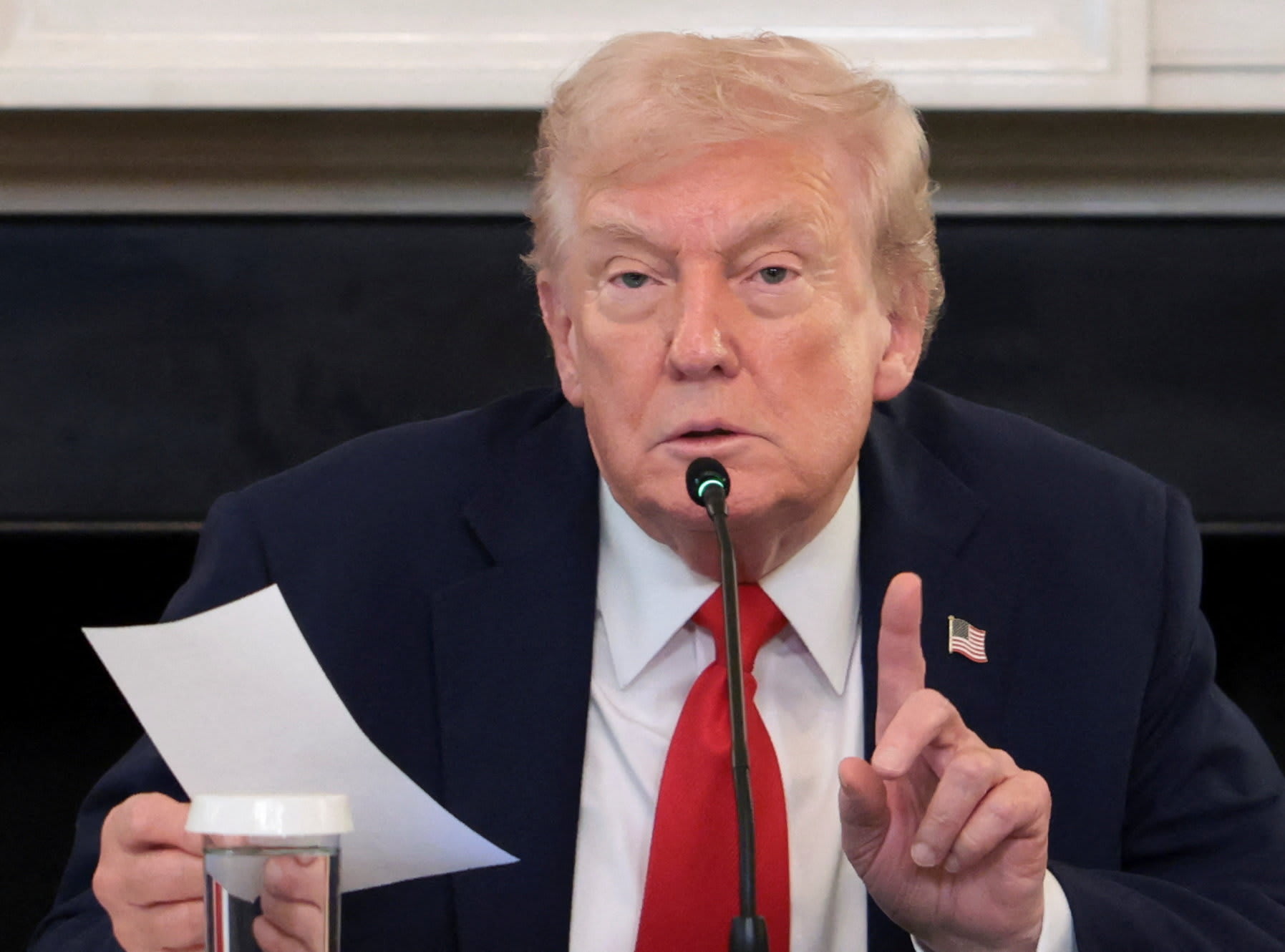 US President Donald Trump holds a note that was handed to him by US Secretary of State Marco Rubio during a roundtable on Antifa, an anti-fascist movement Trump designated a domestic "terrorist organization" via executive order on September 22, at the White House in Washington, October 8, 2025. (photo credit: REUTERS/EVELYN HOCKSTEIN)