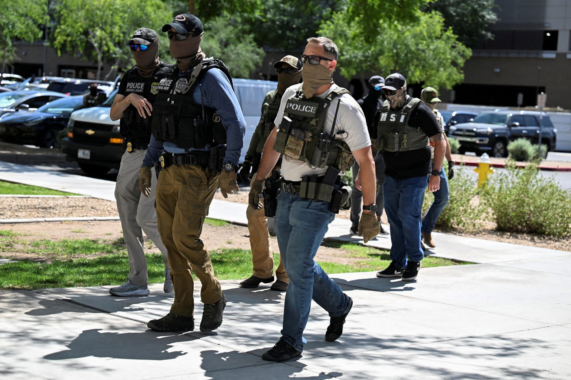 Masked law enforcement officers, including HSI and ICE agents, walk into an immigration court in Phoenix, Arizona, U.S., May 21, 2025. (photo credit: REUTERS)