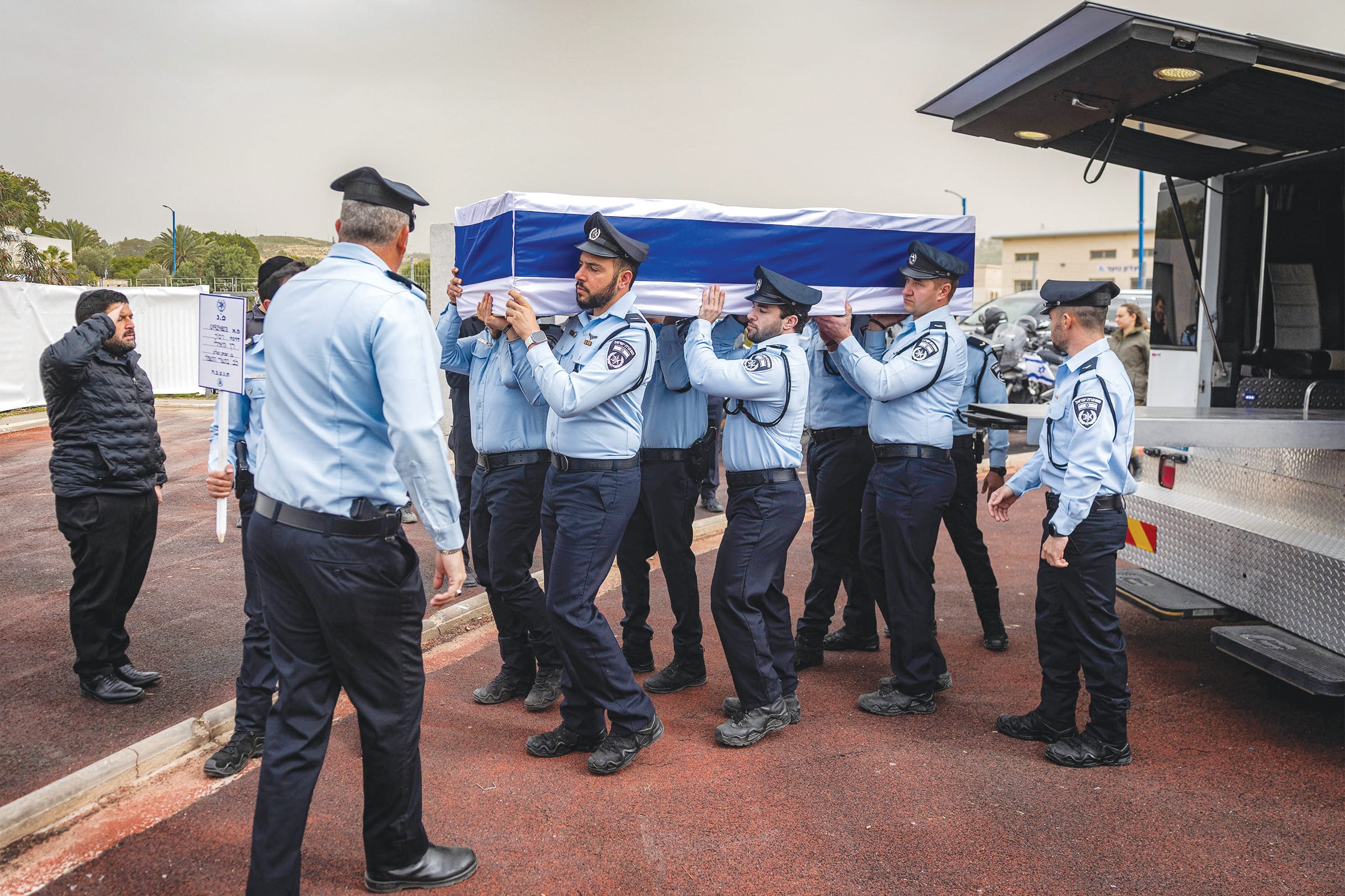 PALLBEARERS FROM the Israel Police prepare to carry Ran Gvili’s casket. (photo credit: CHAIM GOLDBERG/POOL/REUTERS)