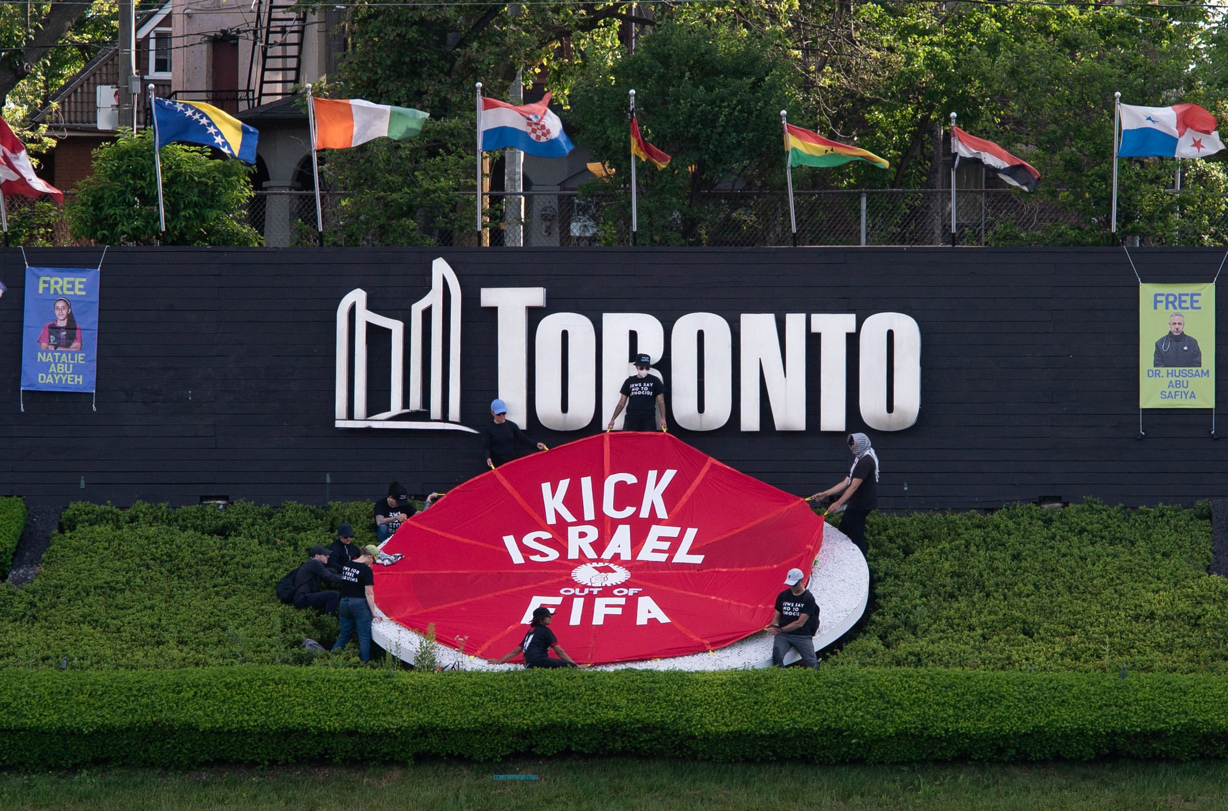  FBL-WC-2026-PRTOEST Activists place a banner covering the logo of the FIFA World Cup 2026 with the words "Kick Israel out of FIFA" in Toronto, Canada, June 12, 2026, on the day of the first game of the Canadian team in the World Cup against Bosnia-Herzegovina.  (photo credit: Jorge UZON / AFP via Getty Images)