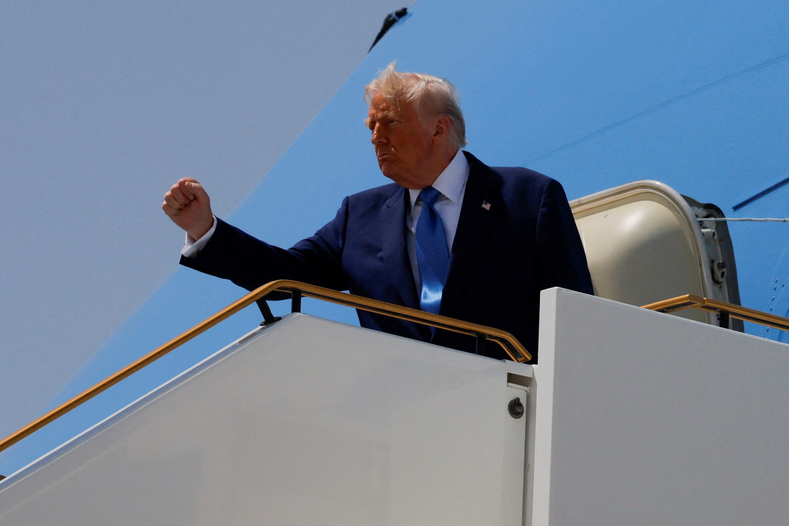  US President Donald Trump gestures, while he boards Air Force One, in Abu Dhabi, United Arab Emirates, May 16, 2025. (photo credit:  REUTERS/Brian Snyder)