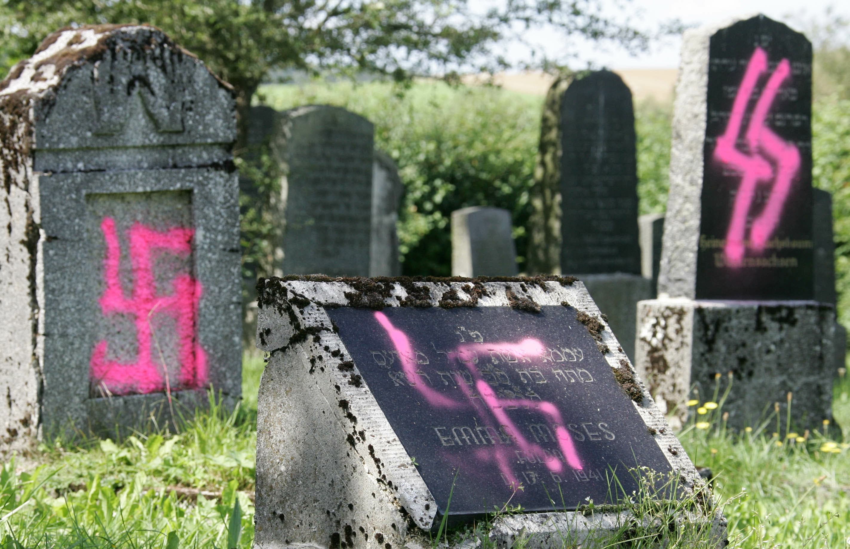 GRAVES DESECRATED by vandals with Nazi swastikas and antisemitic slogans are seen in the Jewish cemetery of Weyhers, Germany, near the city of Ebersburg, Aug. 2005. (photo credit: Fabrizio Bensch/Reuters)