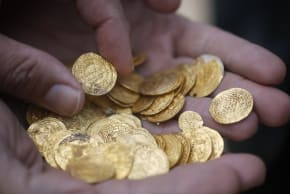 Ancient gold coins are displayed in Caesarea