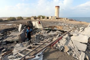 A Palestinian man inspects the scene of an Israeli air strike on a Hamas security forces site in the southern Gaza Strip October 17, 2018