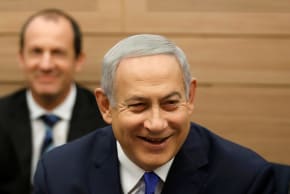 Israeli Prime Minister Benjamin Netanyahu smiles as he attends the Foreign Affairs and Defense Committee at the Knesset, Israel's Parliament, in Jerusalem November 19, 2018