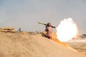 A member of military units of the IRGC Ground Force fires a rocket launcher as they launched war games in the Gulf, December 22, 2018