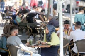 Arab Israelis and Haredi youth at a café in Jerusalem