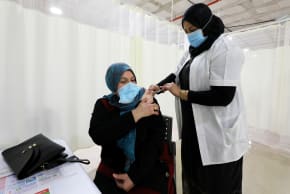 A woman receives a vaccination against the coronavirus disease (COVID-19) at a vaccination center in Umm El-Fahem, Israel January 3, 2021