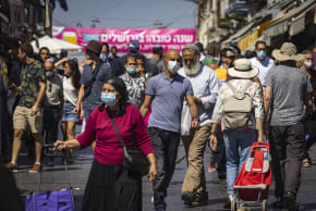  People some with facemasks shop at the Mahane Yehuda market in Jerusalem on September 29, 2021. 