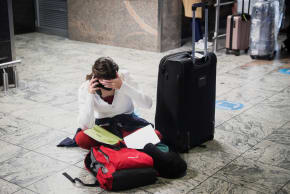 A passenger tries to find a flight as several airlines have stopped flying out of South Africa, amidst the spread of the new SARS-CoV-2 variant Omicron, at O.R. Tambo International Airport in Johannesburg, South Africa, November 28, 2021.