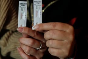  Women show their negative rapid test results after using COVID-19 self-test kits, in Malaga