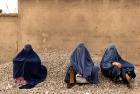  Women wearing burqas pause at the side of a road in Kabul, Afghanistan October 26, 2021.