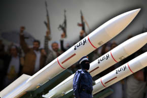 Houthi soldiers stand guard on a missile carrier during an official military parade marking the ninth anniversary of the Houthi takeover of the capital, Sanaa, on September 21, 2023.