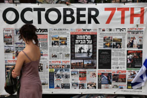 A banner news papers stories of the October the 7th attack is displayed as Israelis react to the news of the Gaza peace deal on October 9, 2025