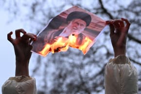 A demonstrator holds a burning photo of Iran's Supreme Leader Ayatollah Ali Khamenei, in London, Britain, January 11, 2026