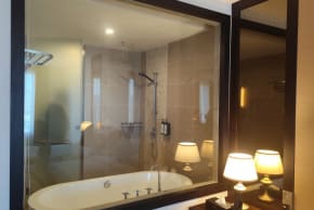 Hotel room with glass bathroom.