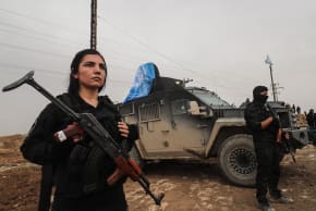 Members of the Kurdish forces stand guard as Syrian government internal security forces enter the northeastern Syrian city of Hasakeh on February 2, 2026.
