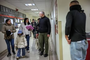  A family is escorted after their hearing in immigration court as masked federal agents patrol the halls at the Jacob K. Javits Federal Building on January 28, 2026 in New York City.