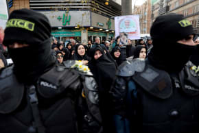 FILE PHOTO: People attend the funeral of the security forces who were killed in the protests that erupted over the collapse of the currency's value in Tehran, Iran, January 14, 2026.
