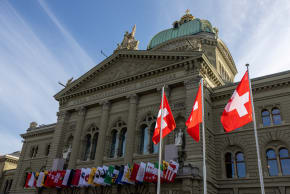 Swiss flags are seen on the Swiss Parliament building (Bundeshaus) in Bern, Switzerland, November 6, 2024.