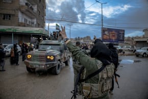  Syrian Public Security Forces drive through a crowd as they enter the Kurdish-majority city of Qamishli in northeastern Syria on February 3, 2026, under an integration deal with Kurdish authorities. 