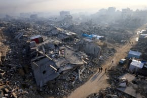  FILE PHOTO: Palestinians walk past the rubble of destroyed buildings, amid a ceasefire between Israel and Hamas, in Gaza City, November 19, 2025.  (photo credit:  REUTERS/Dawoud Abu Alkas/File Photo)