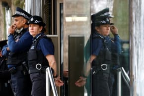 Police officers stand outside New Scotland Yard, the headquarters of the Metropolitan Police, in London, Britain March 21, 2023. 