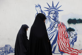 Women walk past an anti-US mural on a street in Tehran, Iran, February 5, 2026