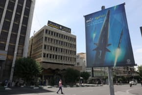A banner with a photo of a new hypersonic ballistic missile called "Fattah" and with text reading "400 seconds to Tel Aviv" is seen on a street in Tehran, Iran June 8, 2023