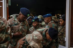 South African National Defence Force (SANDF) soldiers queue to mark a register upon arrival at Tempe Military Base in Bloemfontein on June 14, 2025, following their withdrawal from eastern Democratic Republic of Congo.
