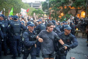 Police officers remove demonstrators gathered at Town Hall Square to protest against President Isaac Herzog's state visit to Australia, in Sydney, Australia, February 9, 2026