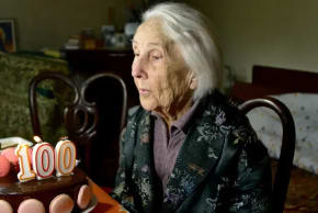 An elderly woman celebrates her 100th birthday