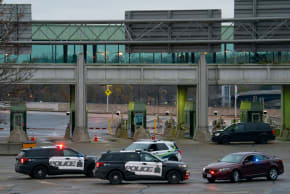 Canadian police cars are seen near the Rainbow Bridge border crossing into the US in Niagara Falls, Ontario on November 22, 2023.