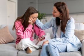 An illustrative image of a supportive mother talking to her child.