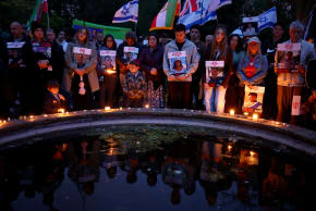 MEMBERS OF the Hostages and Missing Families Forum hold a vigil in London for the one-year anniversary of the October 7 massacre, on October 7, 2024,