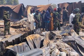 People look on as Nigerian Military arrives at Woro community, after an overnight attack by gunmen that killed dozens of residents, in Kaiama Local Government Area of Kwara State, Nigeria, February 4, 2026. 