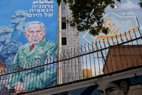 A BILLBOARD with a caricature of Prime Minister Benjamin Netanyahu is displayed on a building in Tehran.